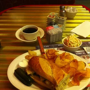 Prime rib with potato salad, pickle and chips...