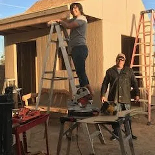 two men working on a house