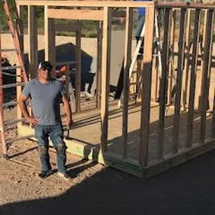 two men working on framing a house