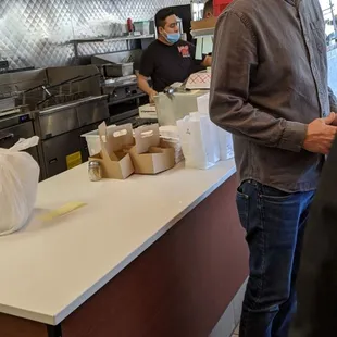 Employee improperly wearing mask while preparing food.