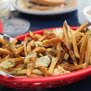 Garlic fries with shaves of parmesan cheese. There is a small menu at the checkout counter.