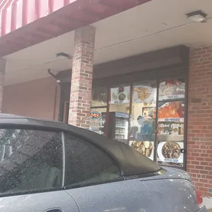 a car parked in front of a restaurant