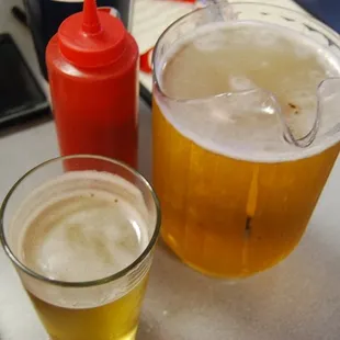 a pitcher of beer and two glasses of beer