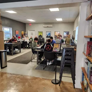 people sitting at desks in a library