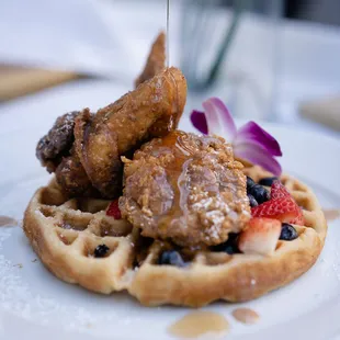 a waffle with fried chicken and berries