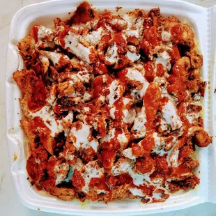 Loaded bowl with chicken shawarma over rice