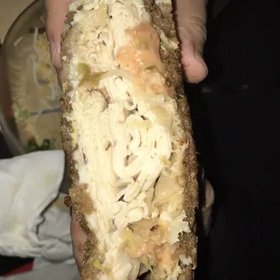 a person holding a sandwich