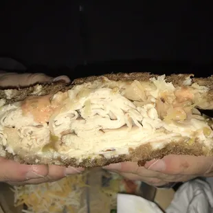 a person holding a sandwich