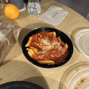 a plate of pasta and a bottle of water