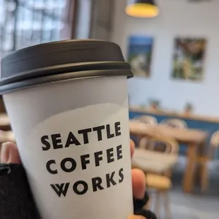 a person holding a coffee cup