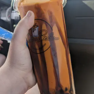 a hand holding a cup of coffee