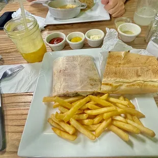 Pressed Philadelphia Cheesesteak, fries, jugo de maracuyá, in the 4 sauce cups (from L to R) is ketchup, mustard, mayo &amp; garlic butter.