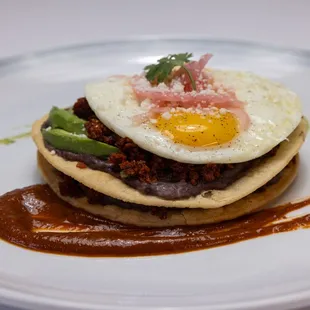 a plate of food with a fried egg on top