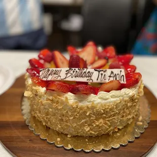 a birthday cake with strawberries on top