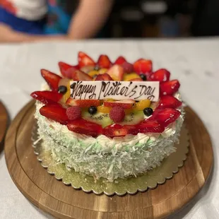 a birthday cake on a wooden plate