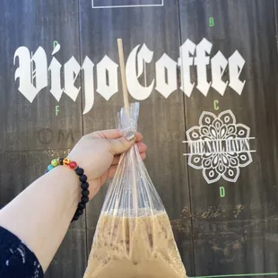 a person holding a bag of coffee