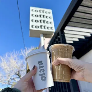 a hand holding a cup of coffee