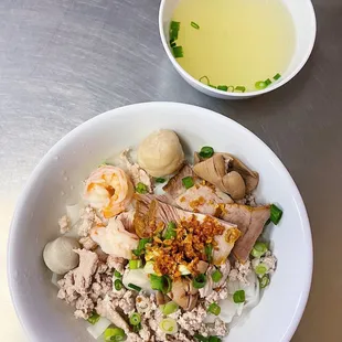 a bowl of rice with meat and vegetables