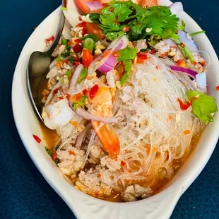 a bowl of noodles with meat and vegetables