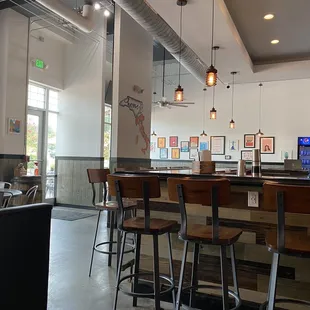 a view of a bar with stools