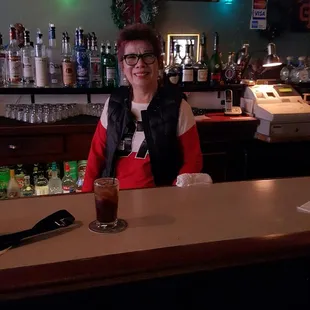 a woman sitting at a bar