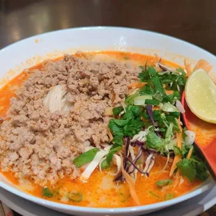 a bowl of soup and chopsticks