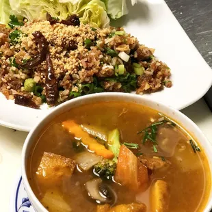 a bowl of soup and a plate of salad