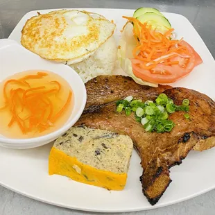 a plate of meat, rice, and vegetables