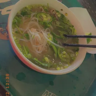 a bowl of soup with noodles and broccoli