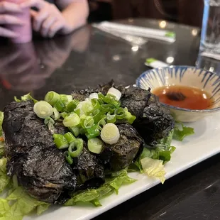 13. Bo La Nho / Grape Leaves Wrapped Beef