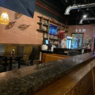 a bar with tables and chairs