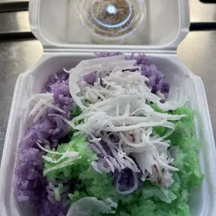 a plastic container filled with rice and vegetables
