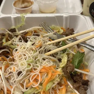 noodles and meat in a styrofoam container