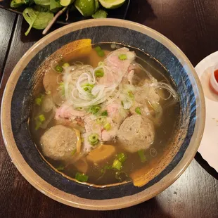 a bowl of soup with meatballs and vegetables