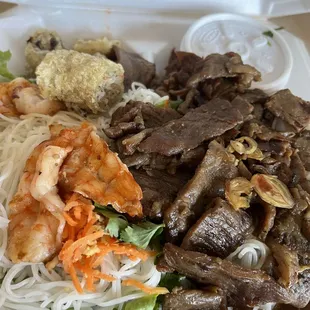 Charbroil shrimp pork and egg rolls over rice noodle