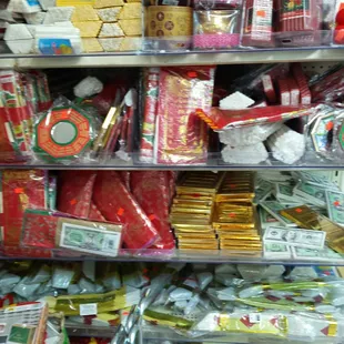 Red envelopes for Lunar New Year, insense, and things to burn for best wishes.
