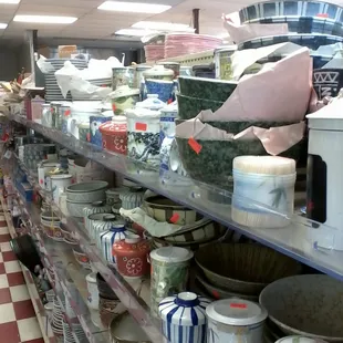 An entire aisle of dishes, crockery, teaware, and cooking supplies
