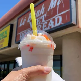 a hand holding a cup of bubble tea