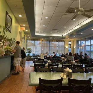 people sitting at tables in a restaurant