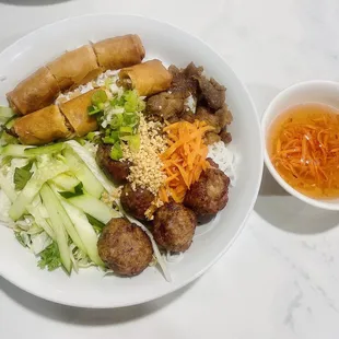a plate of food and a bowl of dipping sauce