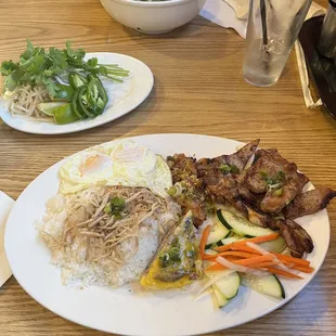 Broken rice with grilled pork, egg pie, fried egg, etc.