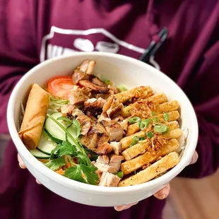 a person holding a bowl of food