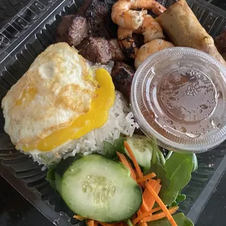 C3. Grill Prawns, Pork Chop & Eggrolls Over Fried Egg Plate