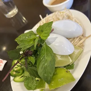 Sides of Cilantro, Lime, Sprouts, Basil I believe, and Jalepeño. Complementary with the Phó