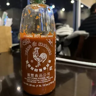a bottle of hot sauce on a table