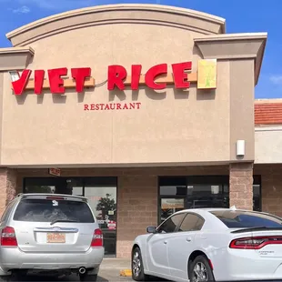 two cars parked in front of a restaurant