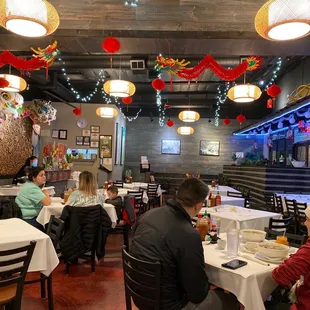 people sitting at tables in a restaurant