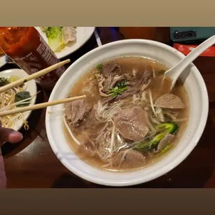 a bowl of soup and chopsticks