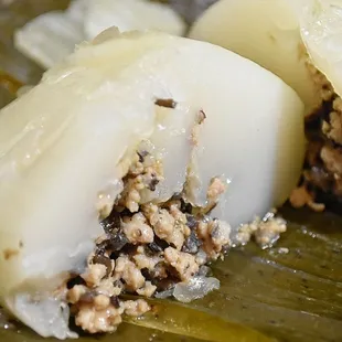 a close up of a piece of food on a banana leaf