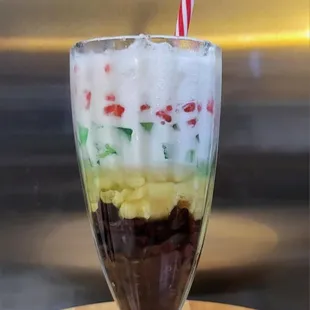 a dessert in a glass with a straw